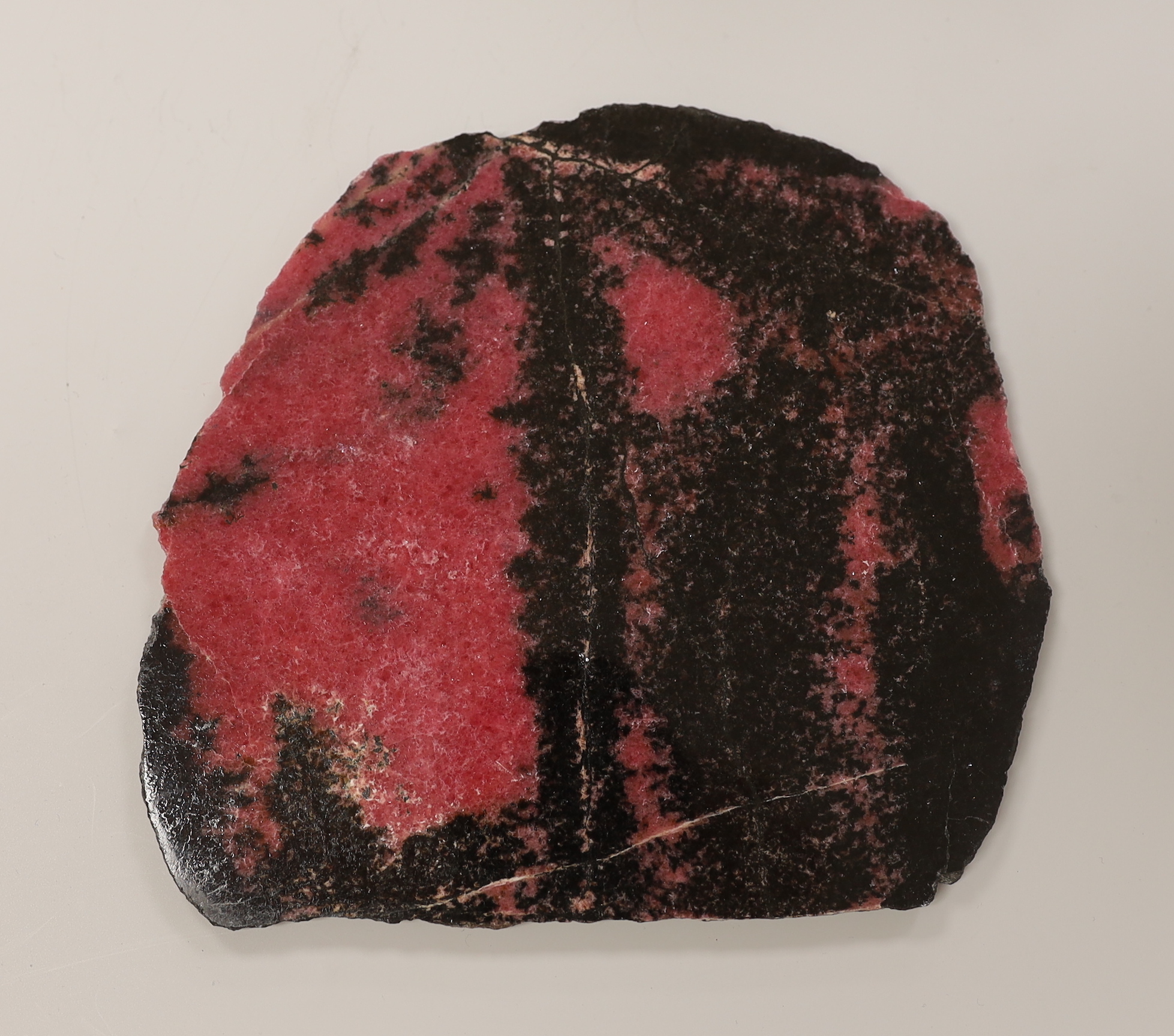 A pink and black quartzite? section. 18cm